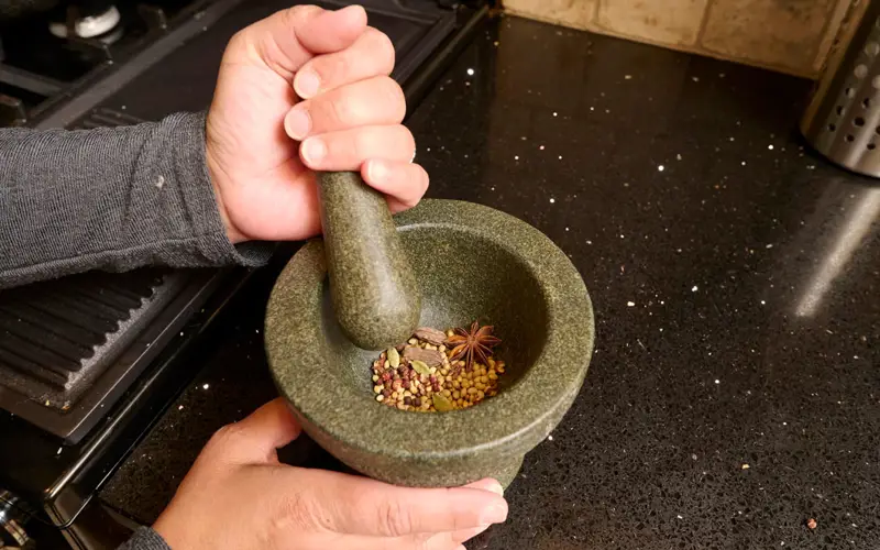 Spices being ground in a pestle and mortar