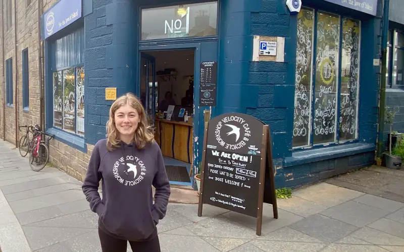 Isabel standing in front of Velocity cafe in inverness