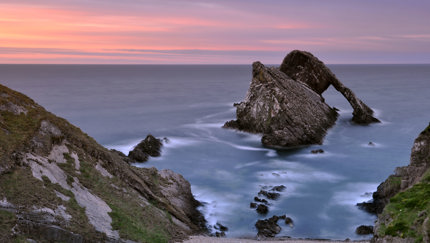 Sunset at Bowfiddle Rock, a natural sea arch near Portknockie