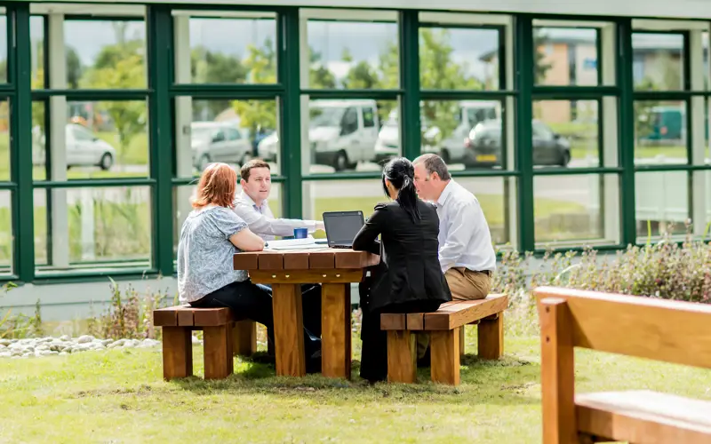 Colleagues using the tranquil shared outdoor space at Horizon Scotland, HIE's Moray office 