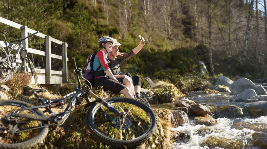 Cairngorm cyclists by river