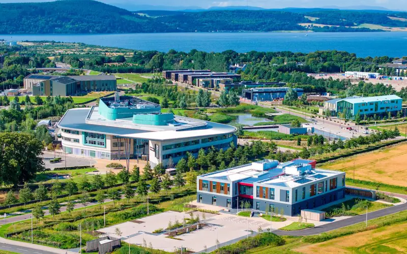 Inverness Campus from above featuring the UHI Inverness College building and looking out to the Inner Moray Firth featuring the Kessock bridge. 