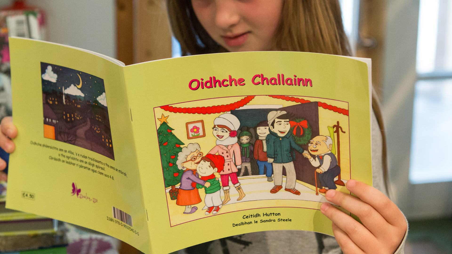 Girl reading Gaelic book 