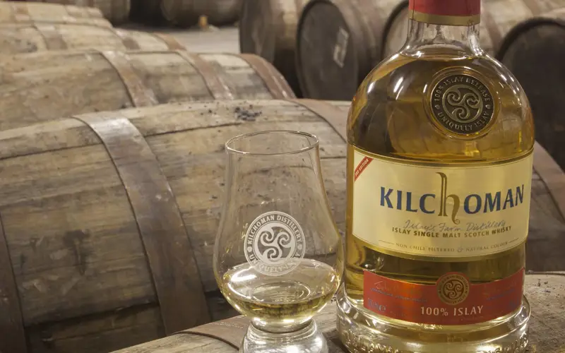 Bottle of Kilchoman whisky and nip glass 
