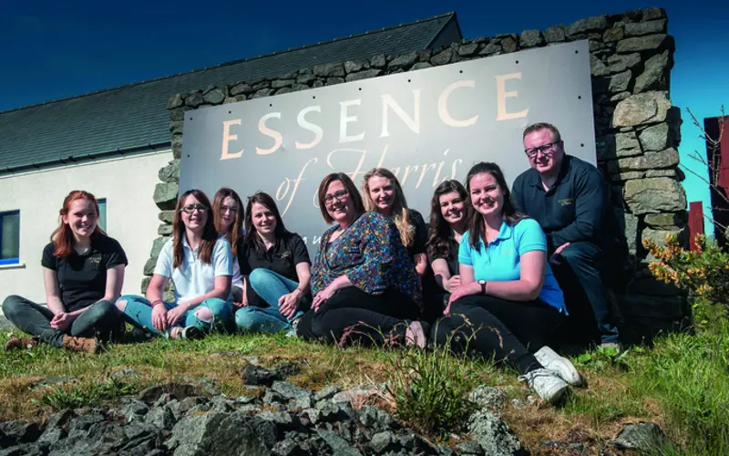 staff from Essence of Harries in front of company sign