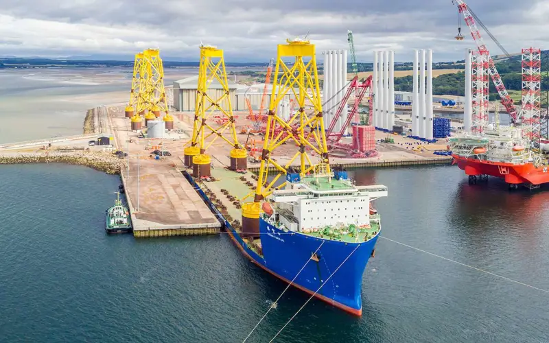 Port of Nigg with large yellow platforms for offshore wind farm